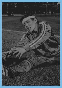 Female in pain exercising on grass - Mackay Acupuncture Natural Medicine